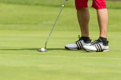 A person is playing golf on the green